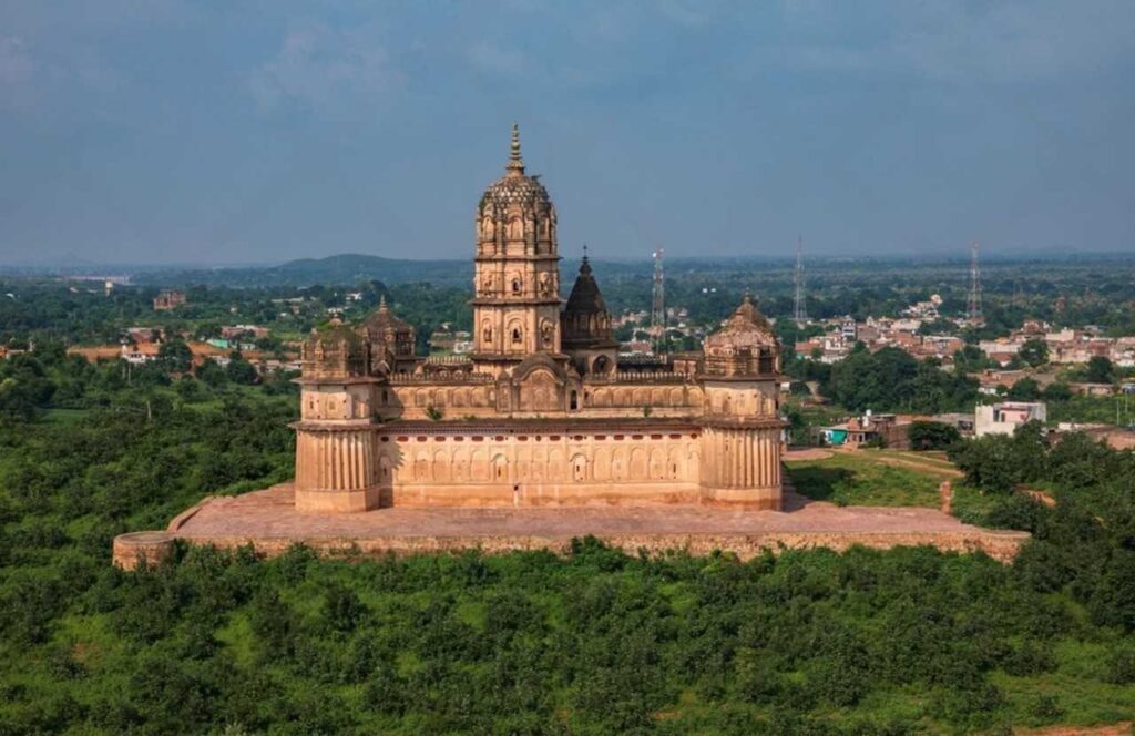 The Laxmi Narayan Temple, the largest in India, is surrounded by a vibrant green field in Orchha.