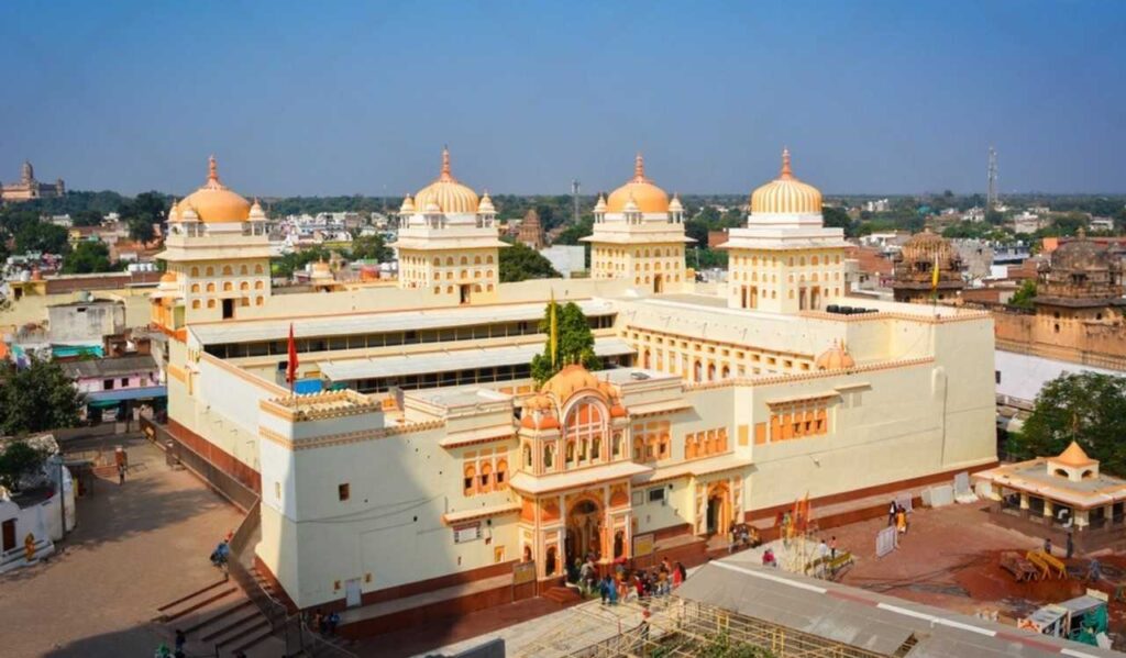 The Ram Raja Temple in Jaipur, India, showcasing intricate architecture and vibrant surroundings under a clear blue sky.