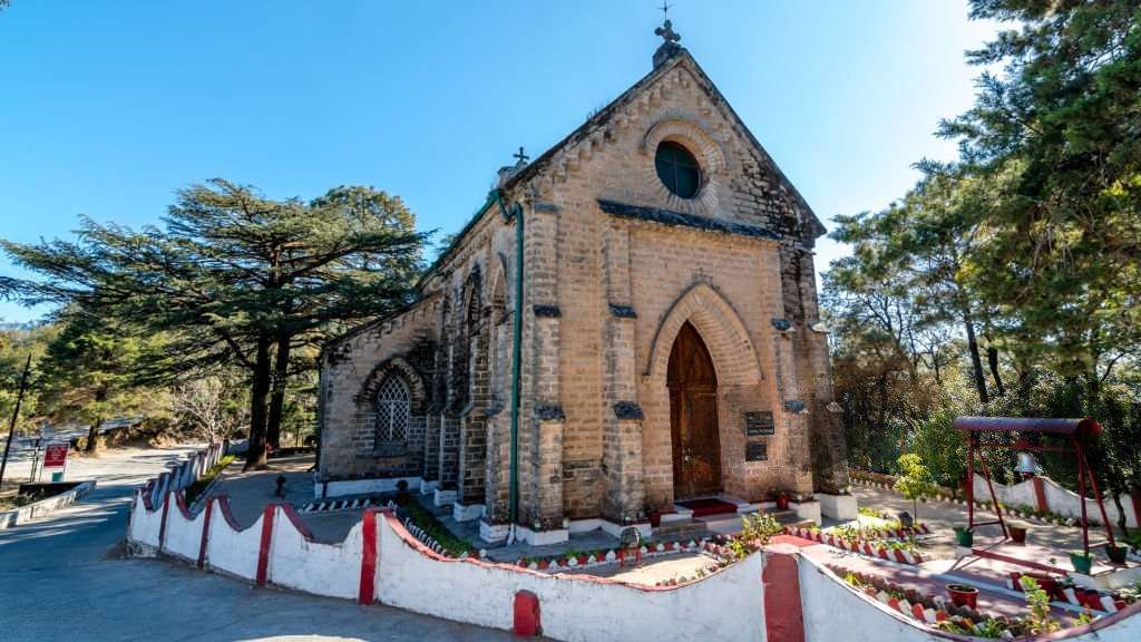 The Church of the Holy Cross, known as St. Mary's Church, lansdowne stands serene in a dense forest setting, highlighting its beauty.