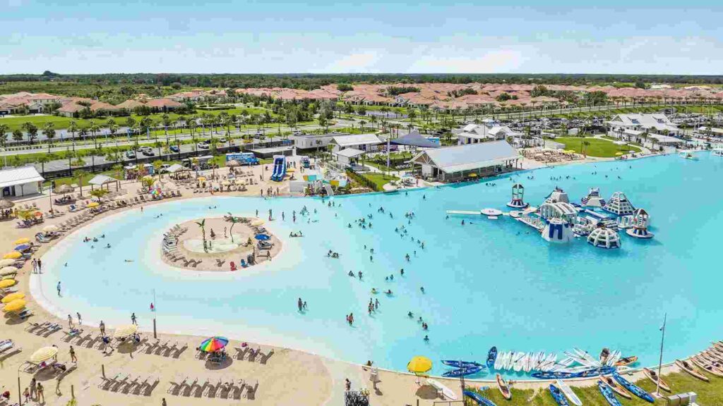 South Shore Bay Lagoon as viewed from sky with crystal blue water and sun loungers alongside water slides and inflatable water park rides.